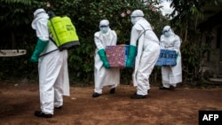 Les agents de santé portent le corps d'un patient atteint du virus Ebola non confirmé à Mangina, près de Beni, dans la province du Nord-Kivu, le 22 août 2018 