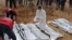 A rescue worker labels bags containing dead bodies of migrants who were washed up on a beach near the city of Zawiya, Libya Feb. 20, 2017. 