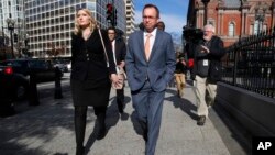 Mick Mulvaney, center, walks to the Eisenhower Executive Office Building after leaving the Consumer Financial Protection Bureau in Washington, Nov. 27, 2017. 