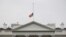 A U.S. flag is seen at half-staff over the White House in Washington, Friday, July 20, 2012. 