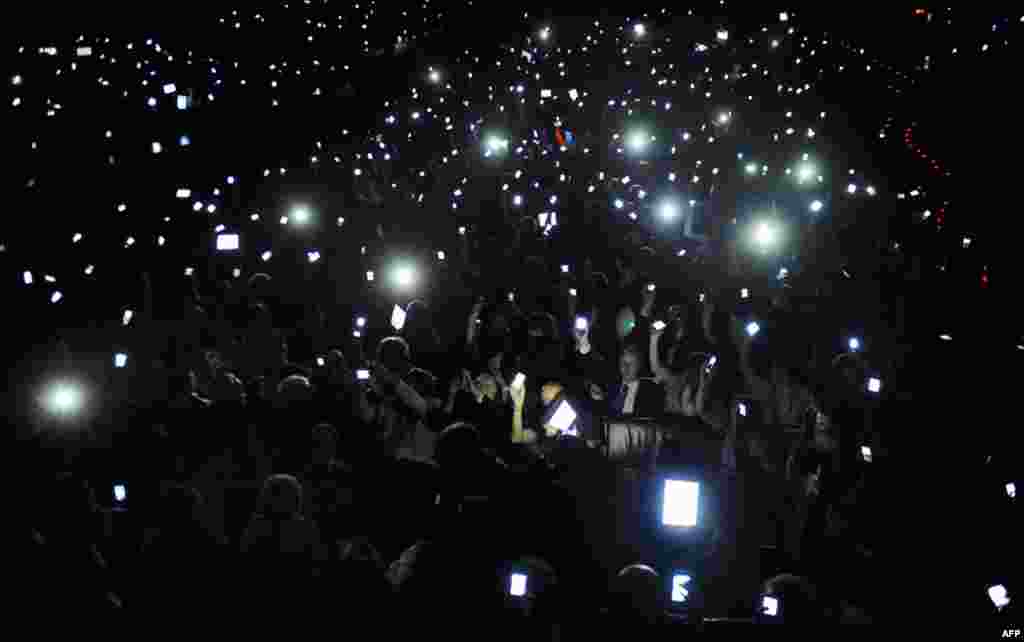 May 17: Delegates hold up mobile devices during the Bilbao Web Summit in the Palacio Euskalduna. (Reuters)