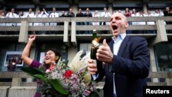 German scientist Benjamin List, who shares the 2021 Nobel Prize in Chemistry together with David MacMillan for the development of asymmetric organocatalysis, celebrates with well-wishers at the Max-Planck-Institute for Coal Research in Muelheim an der Ruhr, Germany.