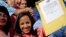 Newly-elected opposition congresswoman Marialbert Barrios holds up her credentials after receiving them from the National Electoral Council (CNE) in Caracas, Venezuela, Dec. 9, 2015.