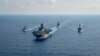 Royal Australian Navy guided-missile frigate HMAS Parramatta (FFH 154) (L) sails with U.S. Navy Amphibious assault ship USS America (LHA 6), Ticonderoga-class guided-missile cruiser USS Bunker Hill (CG 52) and Arleigh-Burke class guided missile destroyer.