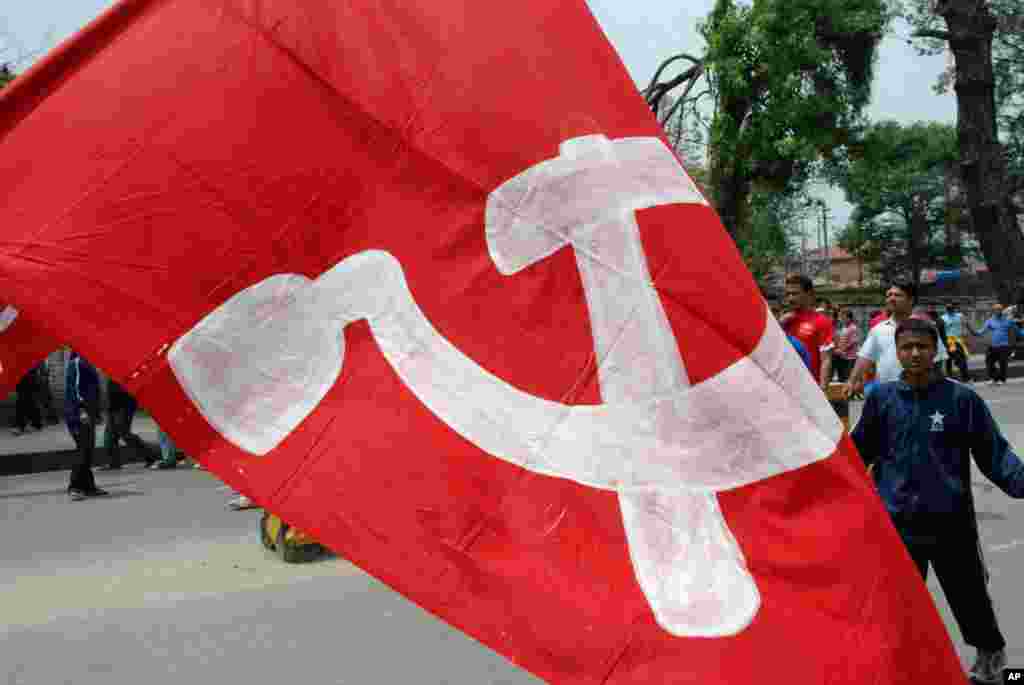 A giant flag carried by a Maoist demonstrator on the streets of Kathmandu, Nepal