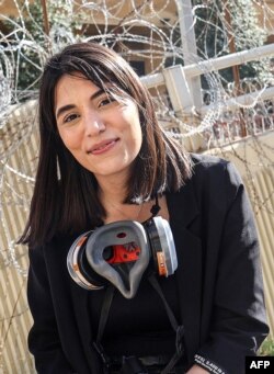 FILE —Lebanese Al-Mayadeen TV reporter Farah Omar looks on during the coverage of a demonstration in Beirut on April 18, 2023.