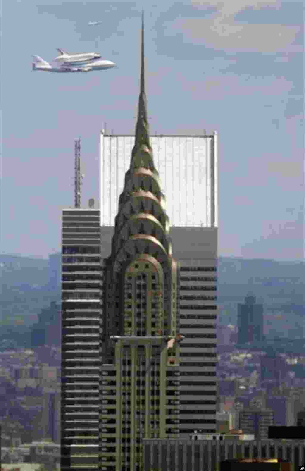 Space shuttle Enterprise, riding on the back of the NASA 747 Shuttle Carrier Aircraft, flies past the Chrysler building as it circles to land at JFK International Airport, Friday, April 27, 2012, in New York. Enterprise is eventually going to make its ne