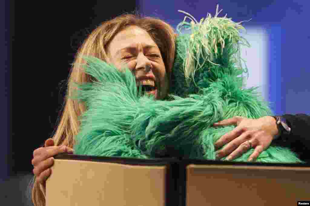 Chelsea Clinton, daughter of former U.S. President Bill Clinton, hugs &quot;Rosita the Muppet&quot; on stage during the Clinton Global Initiative 2013 (CGI) in New York, Sept. 24, 2013.