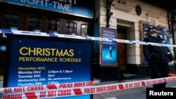 Armed police works in a cordoned off area in a street near Norrebro Station following shootings in Copenhagen, Denmark, Feb. 15, 2015.