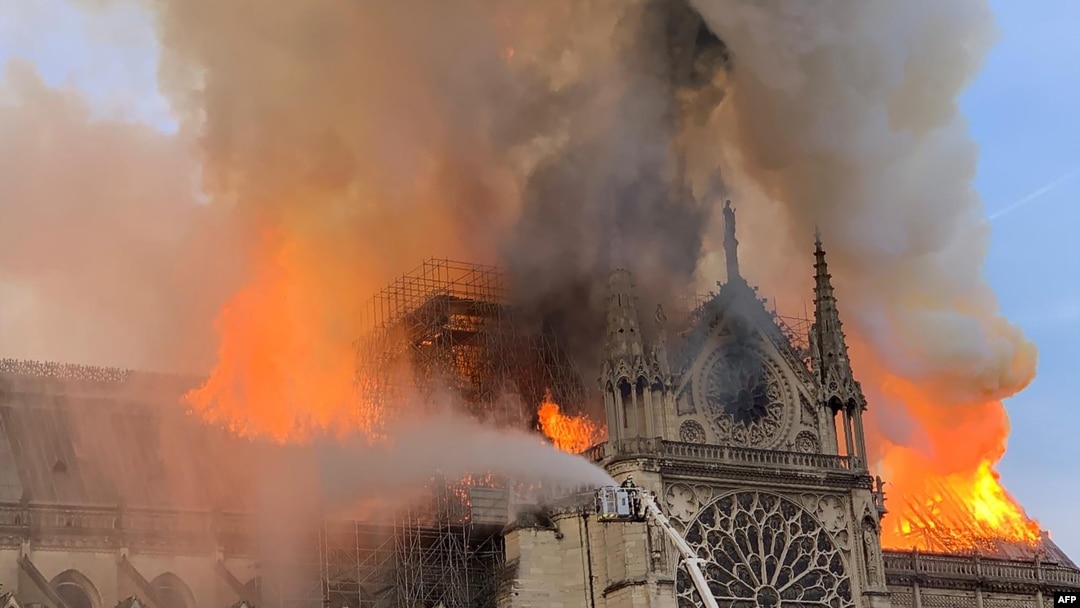 Flames and smoke are seen billowing from the roof at Notre Dame Cathedral in Paris, April 15, 2019.