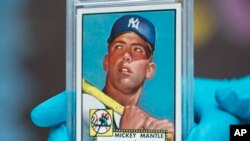 The "Holy Grail" of baseball cards, a 1952 Topps Mickey Mantle that is valued at more than $10 million, is put on display as part of baseball memorabilia exhibit at the Colorado History Museum Monday, July 16, 2018, in Denver. (AP Photo/David Zalubowski)