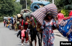 Congolese civilians who fled from Goma, in eastern Democratic Republic of the Congo, walk towards the Grand Barrier crossing point to return home, in Gisenyi, Rubavu district, Rwanda, Jan. 30, 2025.