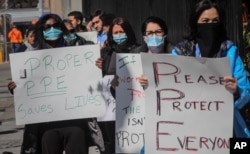 FILE - Nurses at Montefiore Medical Center Moses Division demand N95s and other critical personal protective equipment to handle the COVID-19 outbreak, in New York, April 2, 2020.