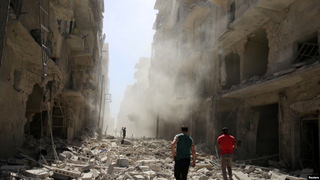 Men inspect the damage after an airstrike on the rebel held al-Qaterji neighbourhood of Aleppo, Syria, Sept. 25, 2016. 