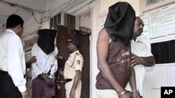 Indian police officials escort alleged pirates at a police station in Mumbai, India (File Photo - January 31, 2011).