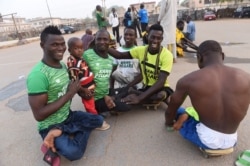 A player for the Kano Pillars para-soccer team holds his son Khalid after a training session in Kano, northwestern Nigeria, on April 22, 2017.