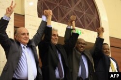 African Union and Ethiopian mediators celebrate after Sudan's protesters and ruling generals inked an agreement in Khartoum, July 17, 2019.