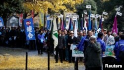 Protesters demanding the return of disputed islands claimed by both Japan and Russia march under ginkgo trees in Tokyo, Dec. 1, 2016. Russian President Vladimir Putin begins a visit to Japan Dec.15.