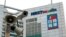 FILE - A security camera is seen in front of the headquarters of Apple Daily and Next Media in Hong Kong.