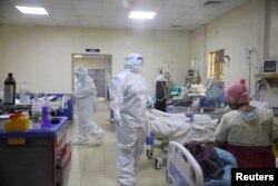 Medical staff dressed in protective suits treat coronavirus disease patients at the COVID-19 ICU of Machakos Level 5 Hospital, in Machakos, Kenya, Oct. 28, 2020.