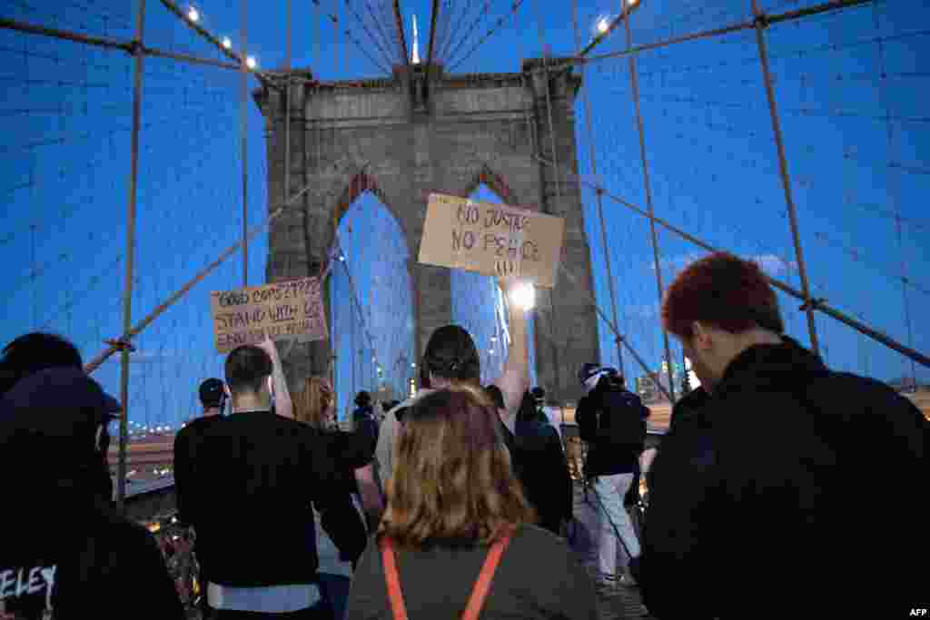 Protesters walk over the Brooklyn Bridge during a march to honor George Floyd in Manhattan on May 31, 2020, in New York City.