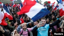 Supporters of French President Elect Emmanuel Macron celebrate near the Louvre museum after early results were announced in the second round vote in the 2017 presidential elections in Paris, France, May 7, 2017. 