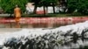 FILE - A monk examines sand bags built around his temple in Bangkok, Thailand, on Nov. 11, 2011. The 2011 floods challenged then-Prime Minister Yingluck Shinawatra's government, just as 2024 flooding threatens to challenge new Prime Minister Paetongtarn Shinawatra.