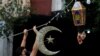 A man puts Ramadan decorations on a street ahead of the Muslim holy month, during a countrywide lockdown over the coronavirus disease (COVID-19) in Beirut, Lebanon, April 19, 2020.