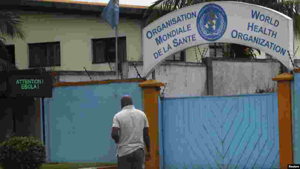 A man walks near a screen displaying a message on Ebola outside the local headquarters of the World Health Organisation (WHO) in Abidjan August 15, 2014. The death toll from the world's worst outbreak of Ebola stood on Wednesday at 1,069 from 1,975 confir