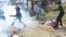 FILE: Armed Zimbabwean police battle rioters in Harare, Monday, July, 4, 2016. (AP Photo/Tsvangirayi Mukwazhi)