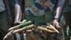 FILE - A South Sudanese army commander holds ammunition captured from opposition fighters in northern Upper Nile State, South Sudan, Aug. 19, 2017.