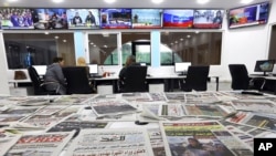 FILE—Newspapers rest on a table at a private television broadcaster in Algiers, Tuesday, March 19, 2024. Algerian officials are chiding television stations over the content choices they've made during Ramadan.