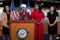 FILE - From left, U.S. Reps. Rashida Tlaib, Ilhan Omar, Ayanna Pressley and Alexandria Ocasio-Cortez respond to remarks by President Donald Trump, at the Capitol in Washington, July 15, 2019.