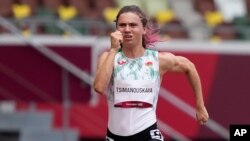 Krystsina Tsimanouskaya, of Belarus, runs in the women's 100-meter run at the 2020 Summer Olympics, July 30, 2021.