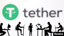 FILE - Figures with computers and smartphones are seen in front of Tether logo in this illustration taken Feb. 19, 2024. 