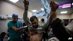 FILE - A Palestinian man wounded in the Israeli bombardment of the Gaza Strip receives treatment at the Nasser hospital in Khan Younis, Southern Gaza Strip, January 22, 2024