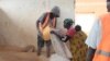 FILE - An undated picture of a woman receiving food aid at Dzaleka refugee camp.