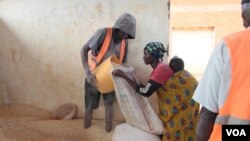 FILE - An undated picture of a woman receiving food aid at Dzaleka refugee camp.