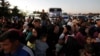 Syrians fleeing the war in Lebanon arrive at the Syrian-Lebanese border crossing in Jdeidet Yabous, Syria, Sept. 25, 2024.