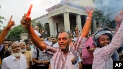Supporters of ousted Sri Lankan Prime Minister Ranil Wickremesinghe celebrate outside the supreme court complex in Colombo, Dec. 13, 2018. 