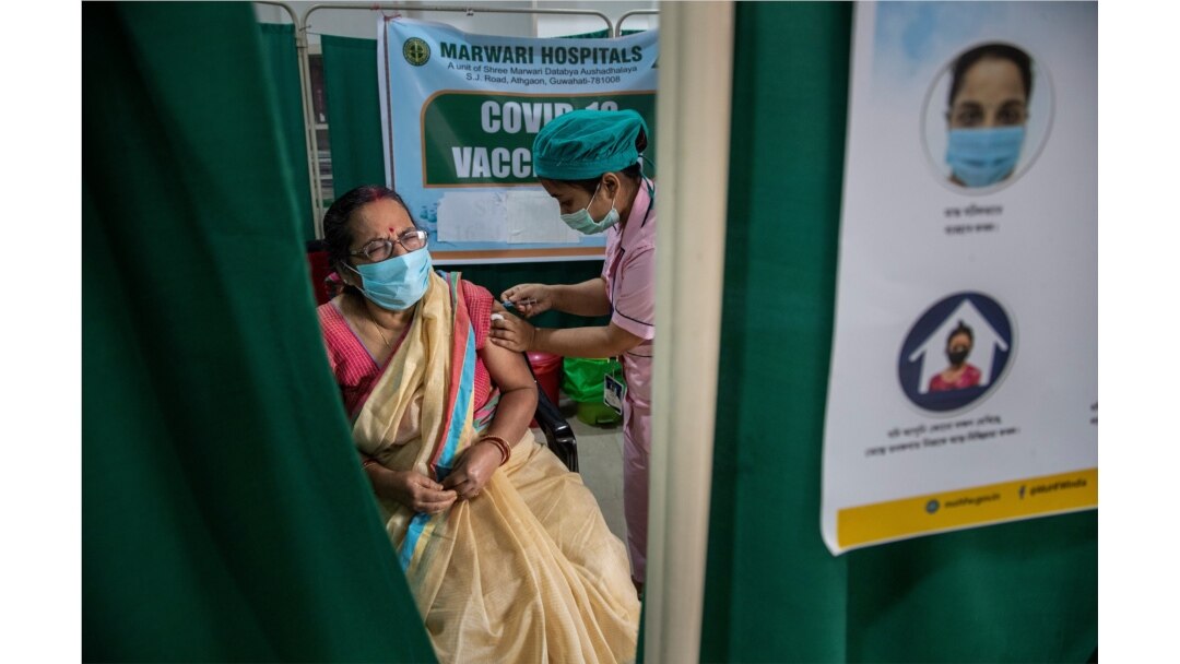 An elderly woman receives the COVID-19 vaccine at a private hospital in Gauhati, India, March 4, 2021.