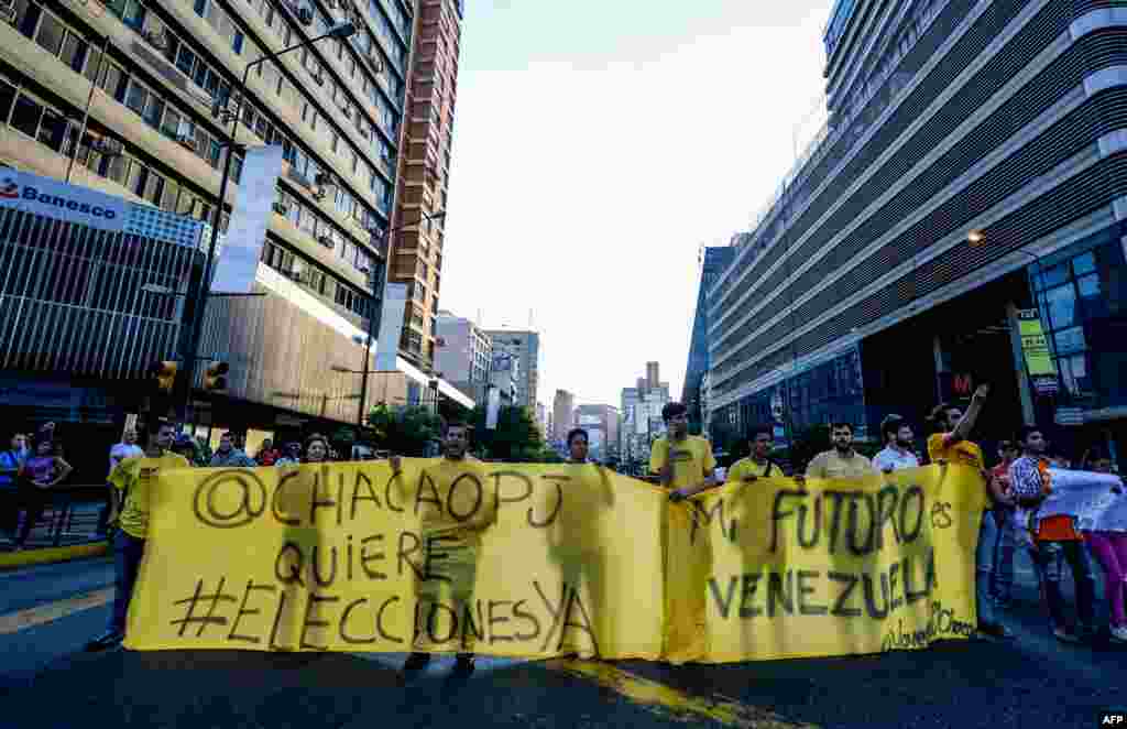 Venezuelan opposition activists, chanting slogans against the government of President Nicolas Maduro, march along a street of Caracas, March 31, 2017.