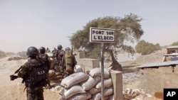 FILE - Cameroon soldiers stand guard at a lookout post near the village of Fotokol as they take part in operations against the extremist group Boko Haram, Feb. 25, 2015.