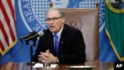 Washington Gov. Jay Inslee speaks after signing a bill, March 5, 2018, in Olympia, Washington, that makes Washington the first state to set up its own net-neutrality requirements in response to the FCC's recent repeal of Obama-era rules. 