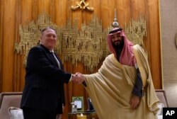 U.S. Secretary of State Mike Pompeo, left, shakes hands with Saudi Arabia's Crown Prince Mohammed bin Salman at Irqah Palace, in the capital Riyadh Saudi Arabia, Feb. 20, 2020.