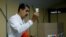 Venezuela's President Nicolas Maduro shows his ballot during an electoral referendum over Venezuela's rights to the potentially oil-rich region of Esequiba, which has long been the subject of a border dispute between Venezuela and Guyana, in Caracas, Venezuela, Dec. 3, 2023