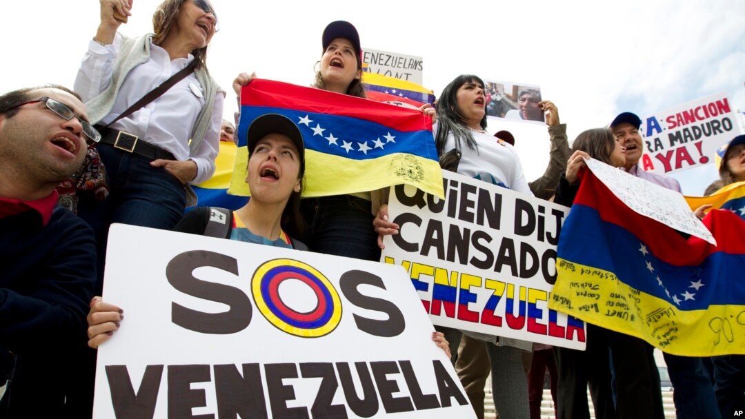 FILE - Demonstrators who are against the Venezuelan government chant outside of the Organization of American States (OAS) during the special meeting of the Permanent Council, in Washington, April 3, 2017, to consider the recent events in Venezuela.