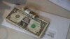 Tips, money collected from a customer donation fund and a last paycheck for employees laid off from Farley’s East cafe, that closed due to the coronavirus outbreak, sits on a counter at the cafe in Oakland, California, March 18, 2020.