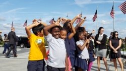 Fourth-graders from Amidon-Bowen Elementary School in Washington show their "Every Kid in the Outdoors" passes that give them free access to national parks, Sept. 19, 2019. (P. Widakuswara/VOA))