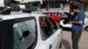 Afghan journalists films the vehicle in which director of Afghanistan's Government Information Media Center Dawa Khan Menapal was shot dead in Kabul, Afghanistan, Aug. 6, 2021.